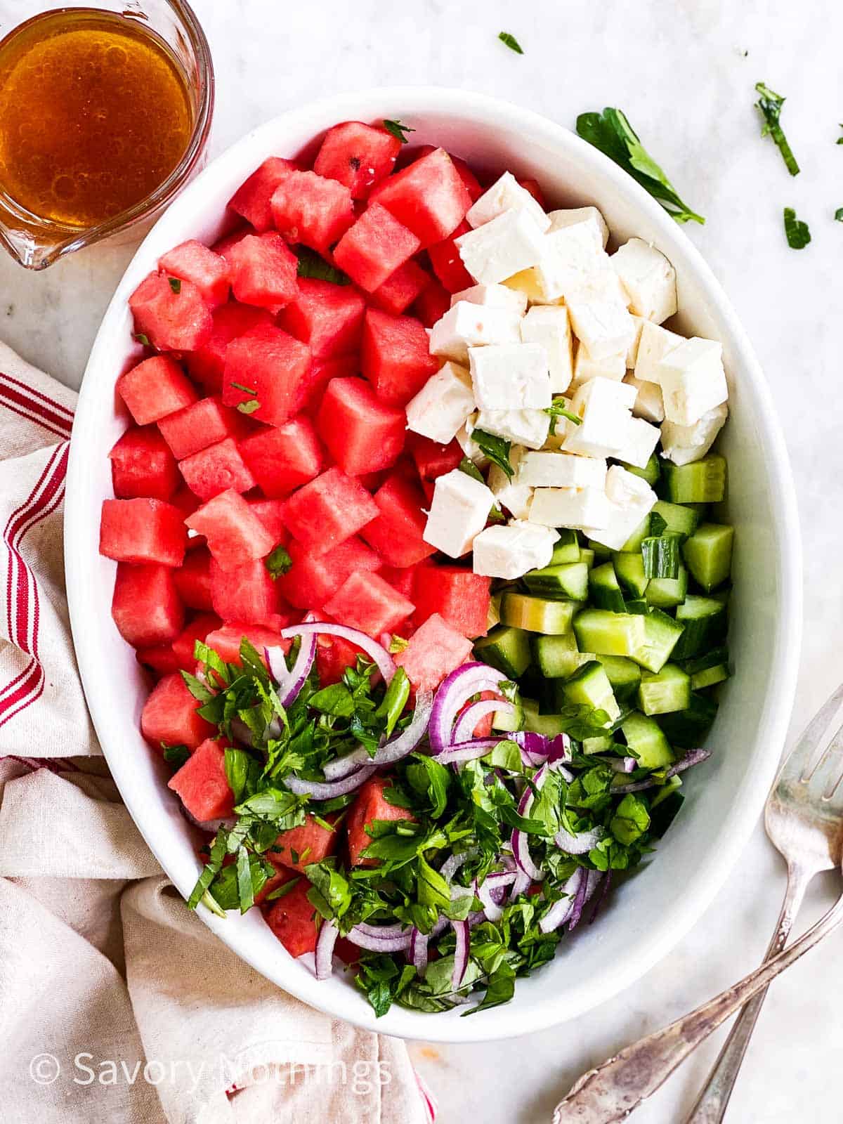 ingredients for watermelon salad in white oval dish