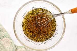 Poppy seed dressing for fruit salad in a glass bowl.