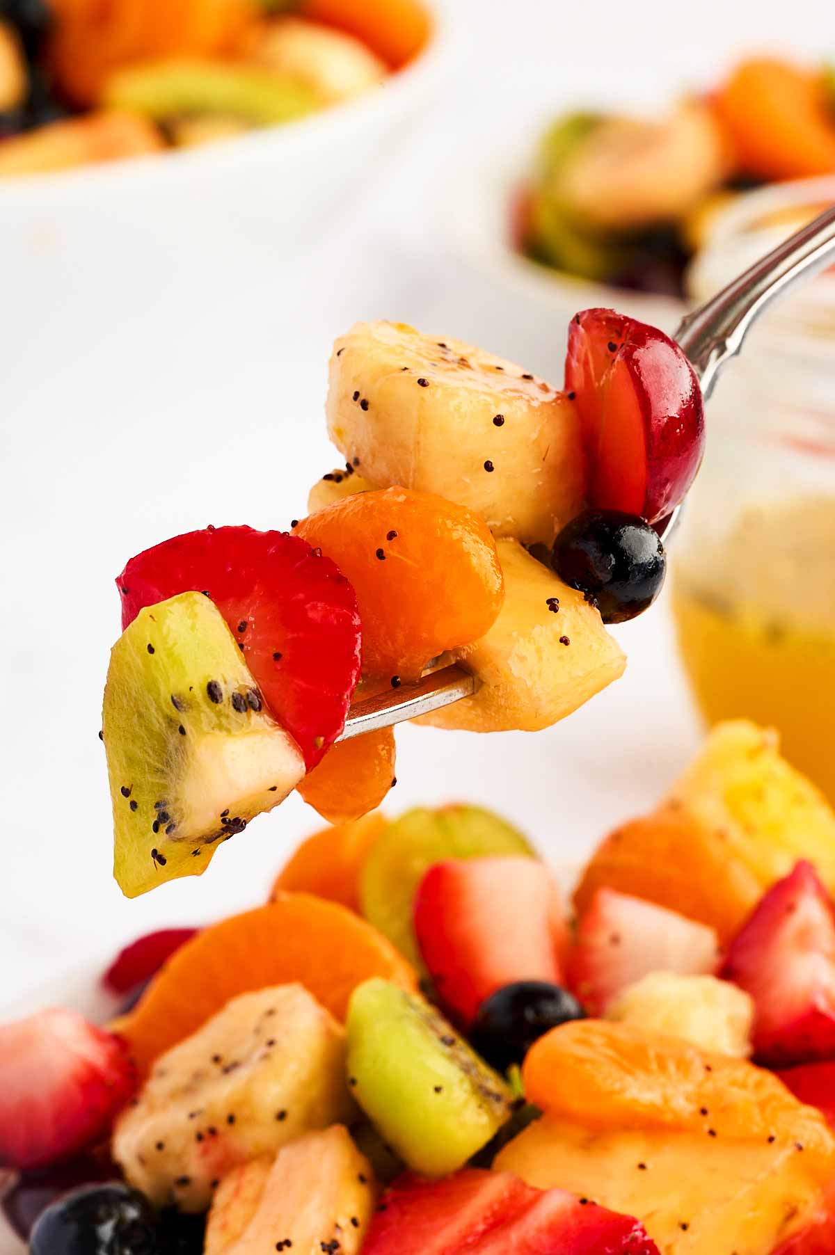 Fruit salad on a fork.