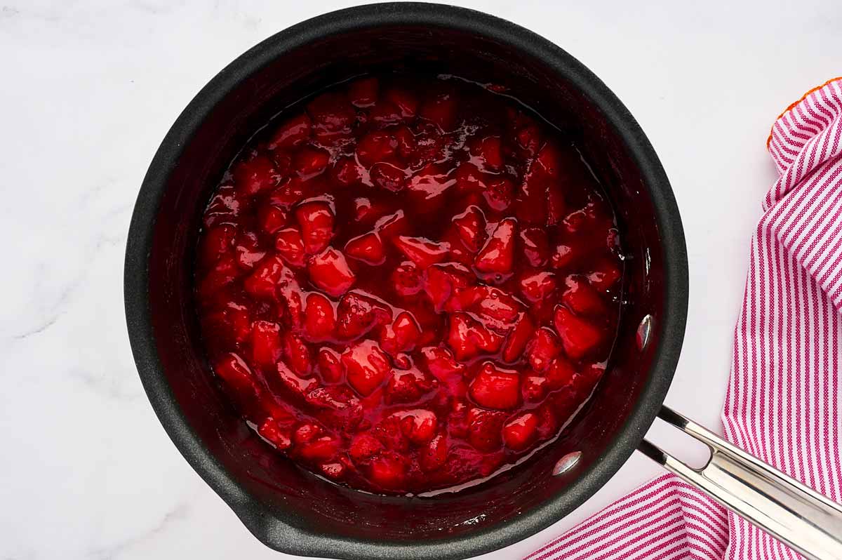 Cooked strawberry filling in pot.