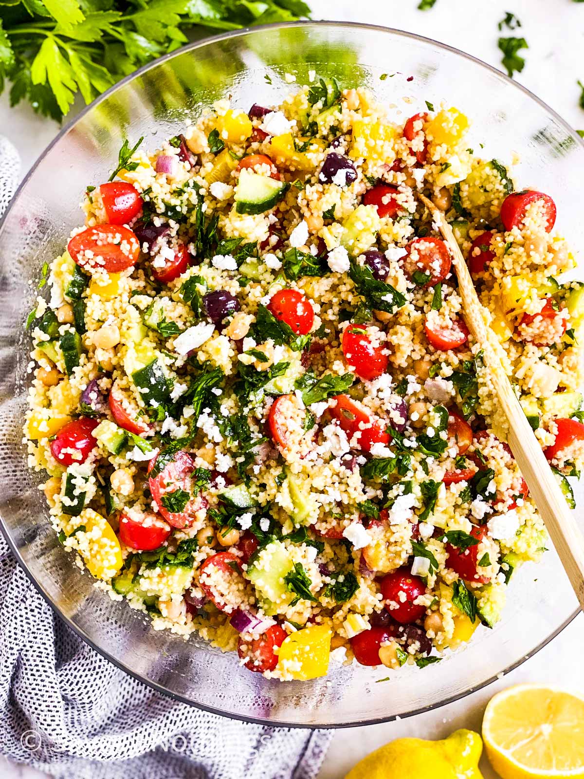 overhead view of glass bowl filled with mediterranean couscous salad