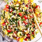 overhead view of glass bowl filled with mediterranean couscous salad