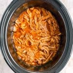 overhead view of pineapple pulled pork in slow cooker