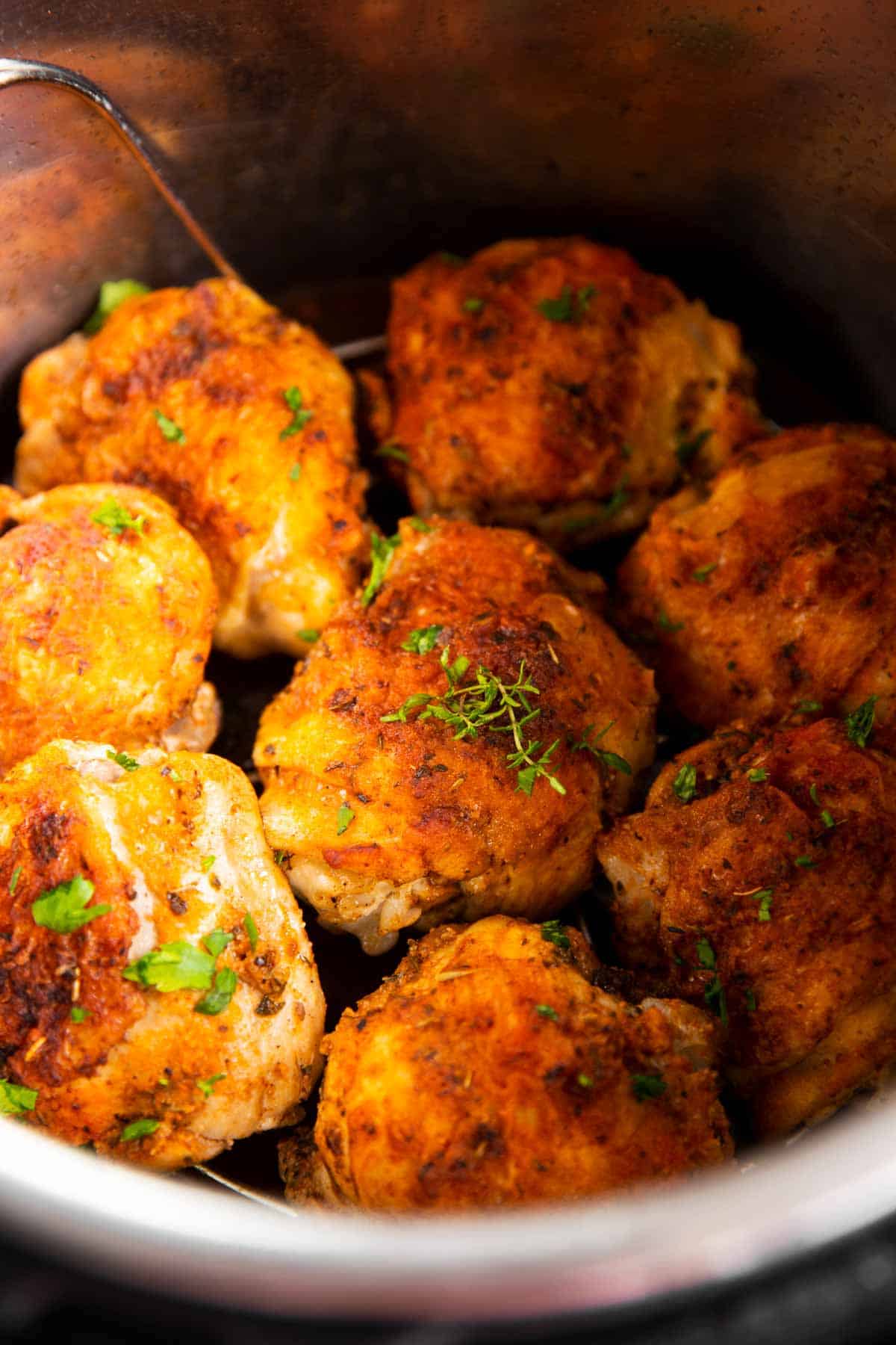 close up photo of eight cooked chicken thighs in instant pot