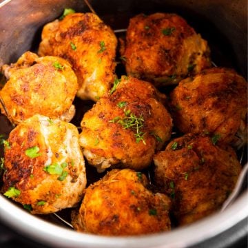 close up photo of eight cooked chicken thighs in instant pot