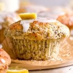 frontal close up view of glazed lemon poppy seed muffin
