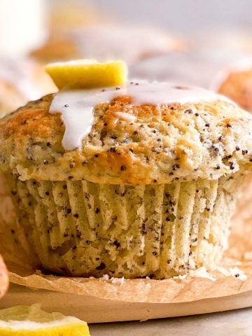 frontal close up view of glazed lemon poppy seed muffin