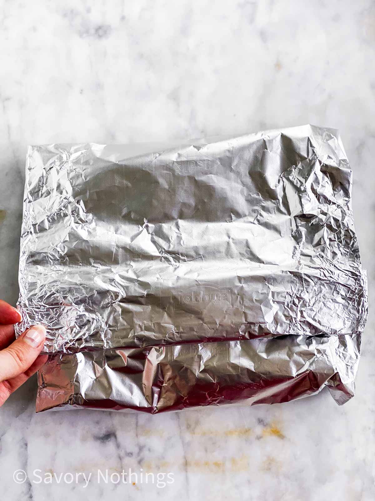 female hands folding down foil packet