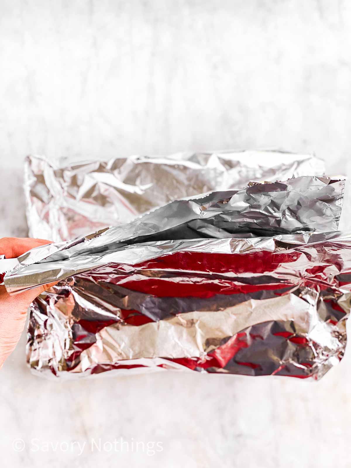 female hands holding ends of foil packet