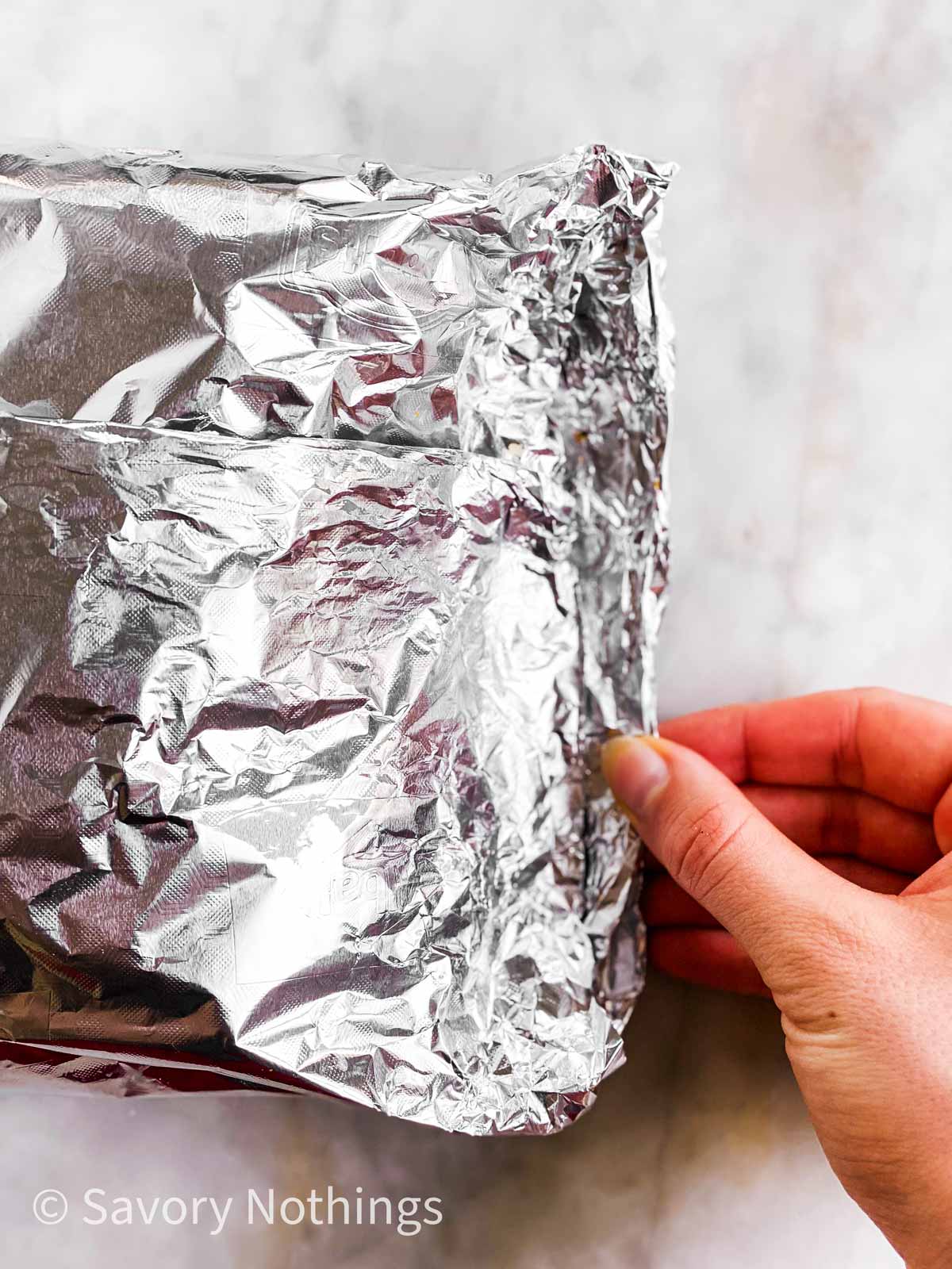 female hand folding out side of foil packet