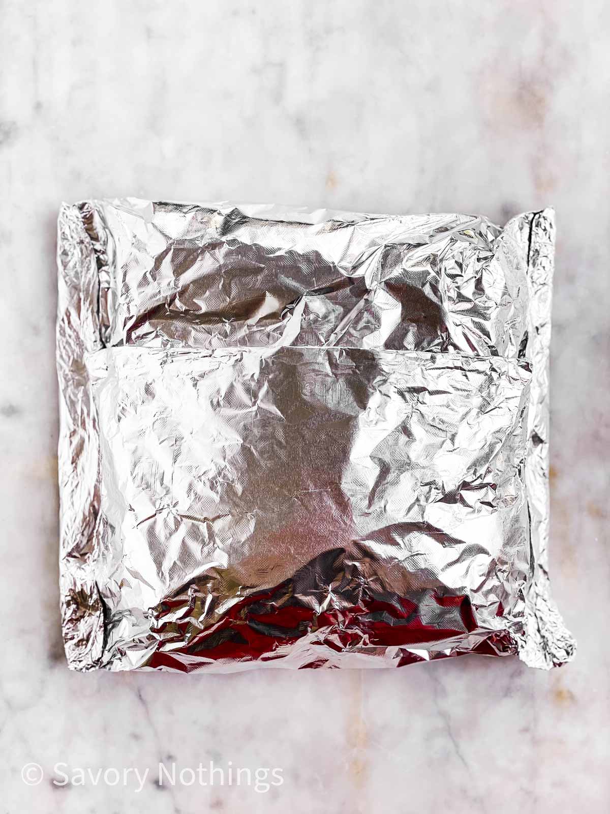 sealed foil packet on light marble surface