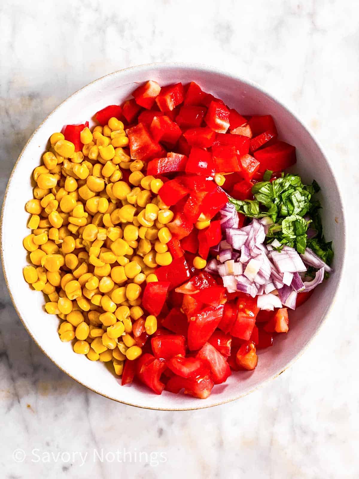 ingredients for summer corn salad in white bowl