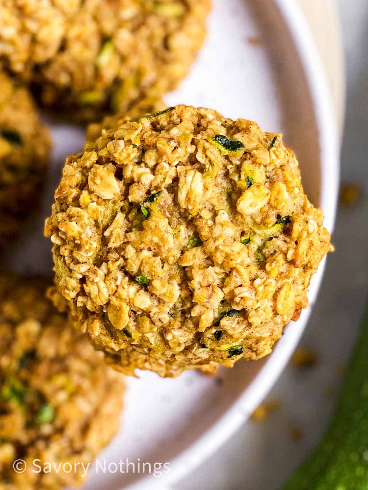 overhead close up view of zucchini bread breakfast cookies on white plate