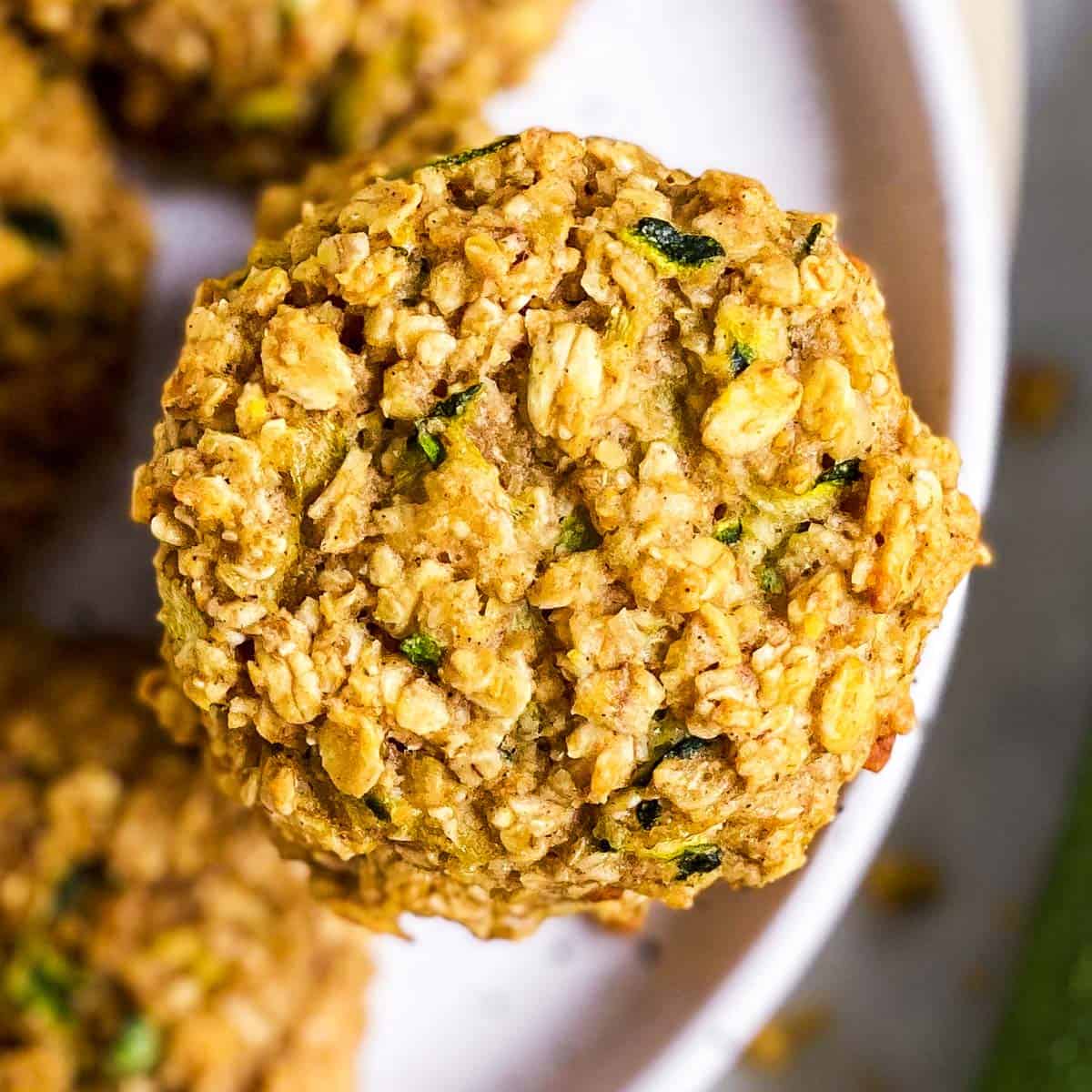 overhead close up view of zucchini bread breakfast cookies on white plate