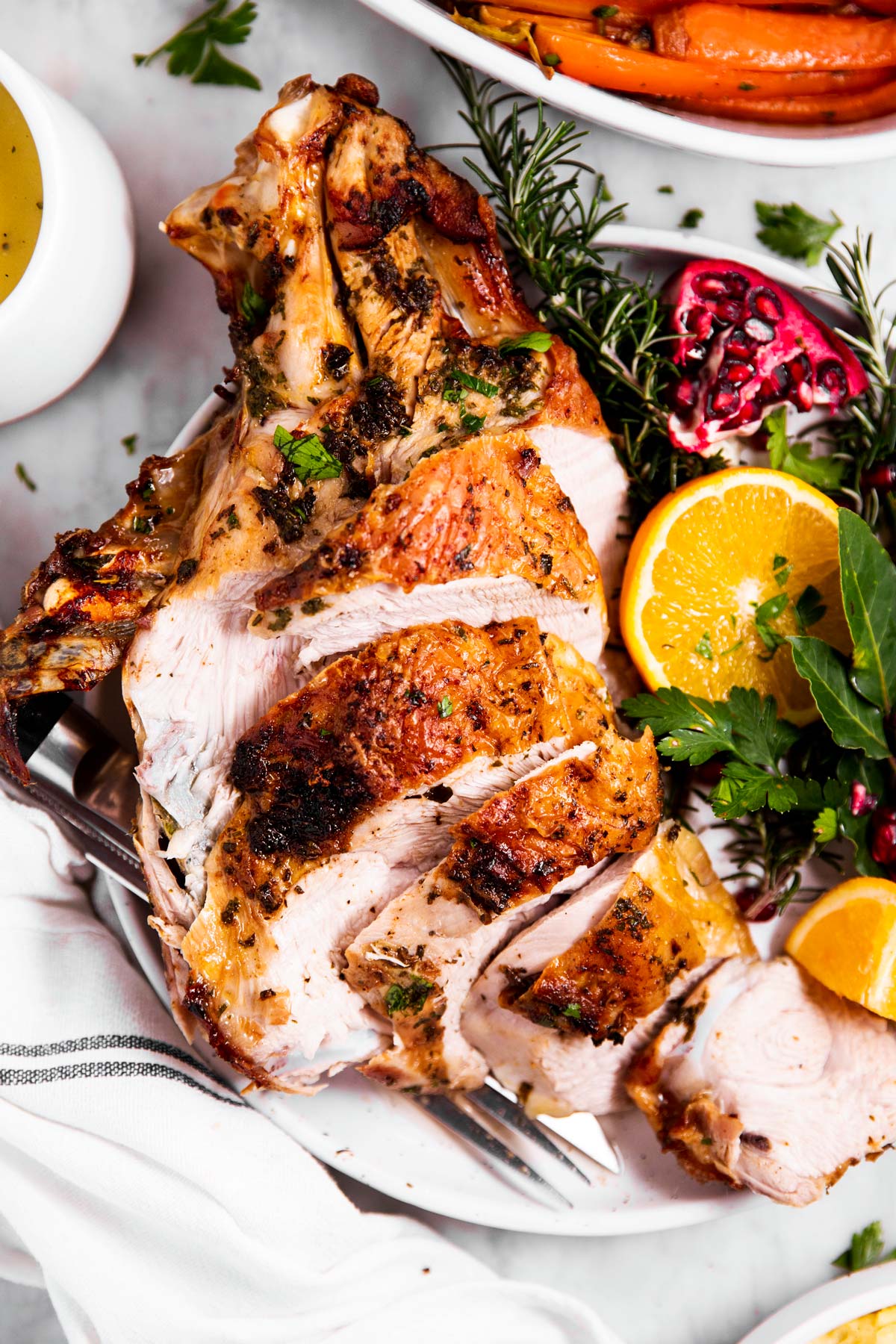 overhead view of carved air fryer turkey breast on garnished plate