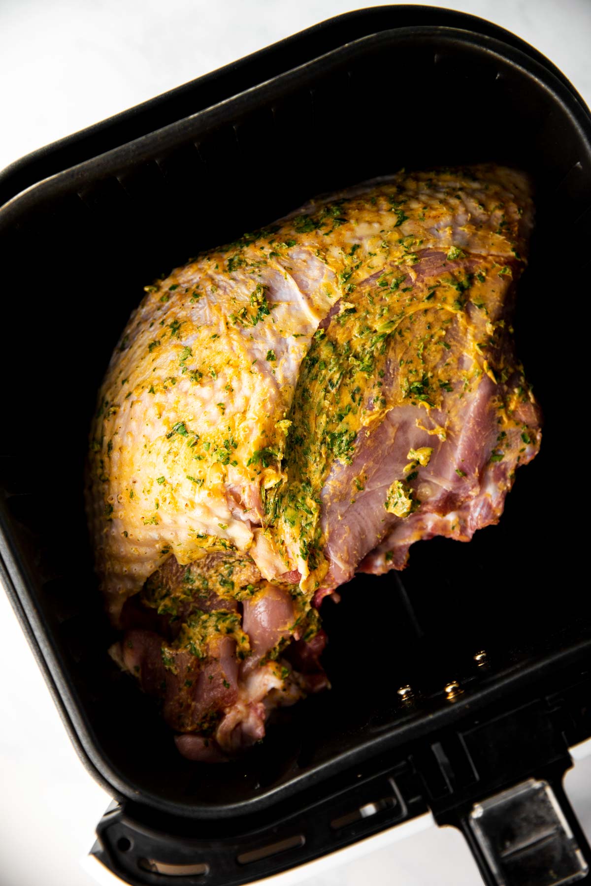 seasoned turkey breast in air fryer basket