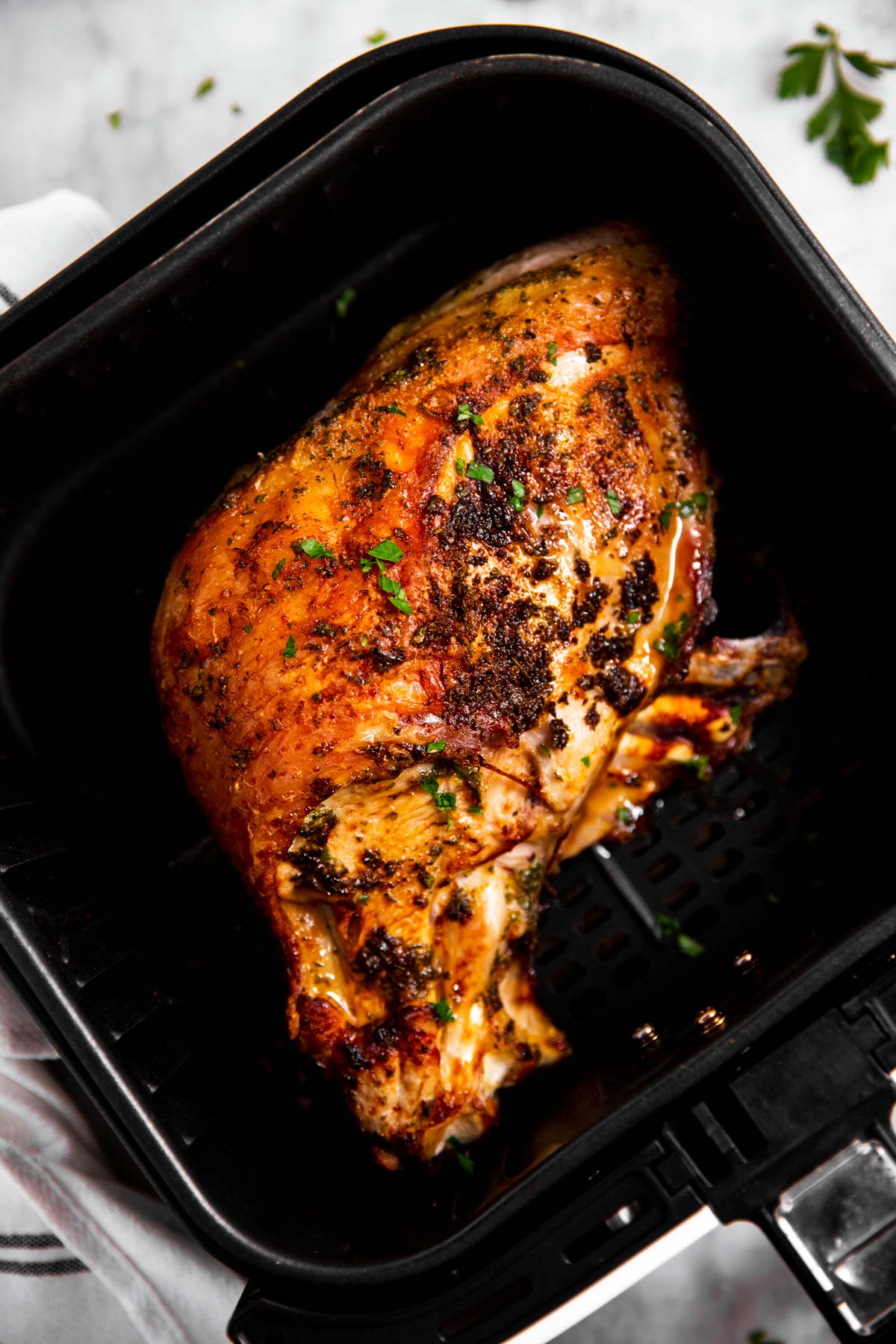 overhead view of turkey breast in air fryer basket