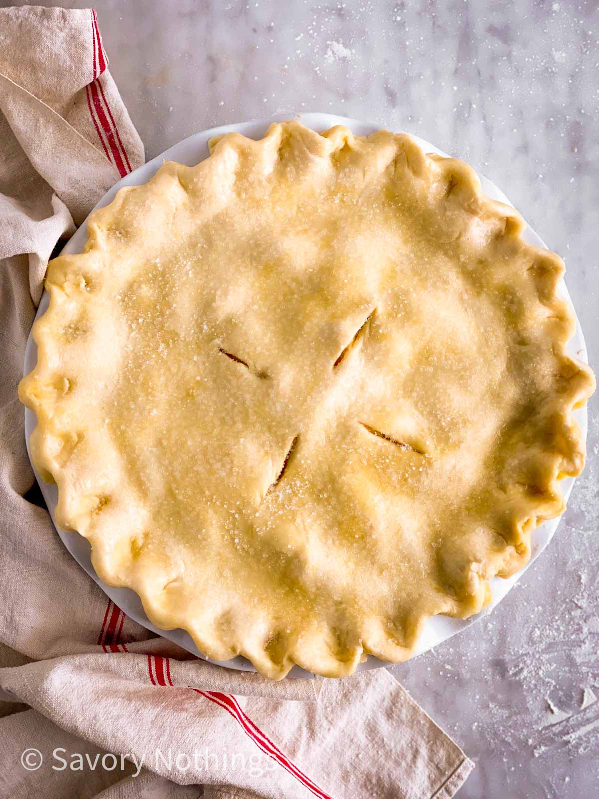 unbaked apple pie on marble surface