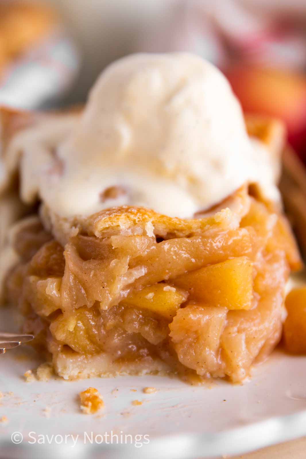 frontal view of apple pie slice with bite taken away