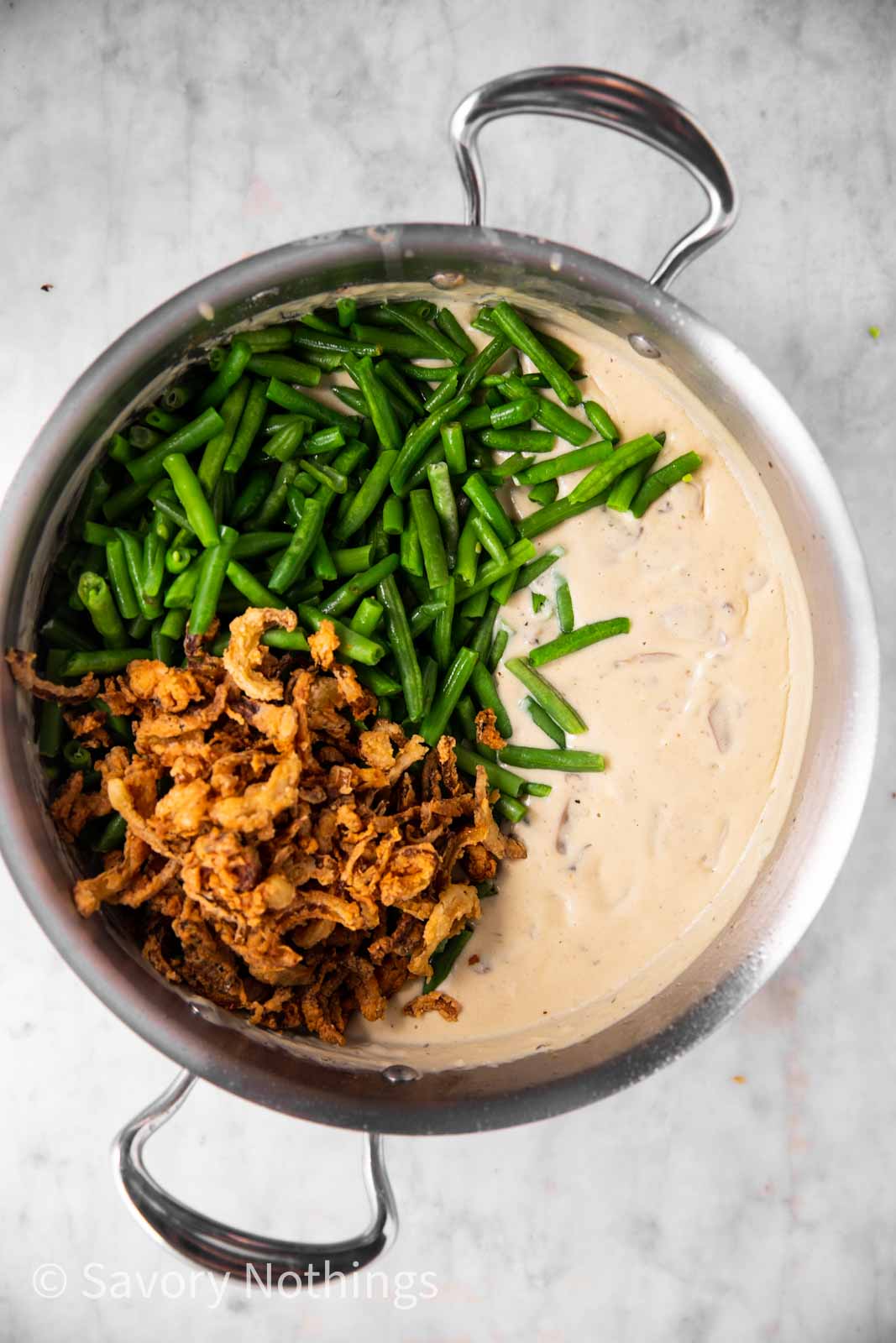 creamy mushroom sauce with green beans and fried onions in skillet