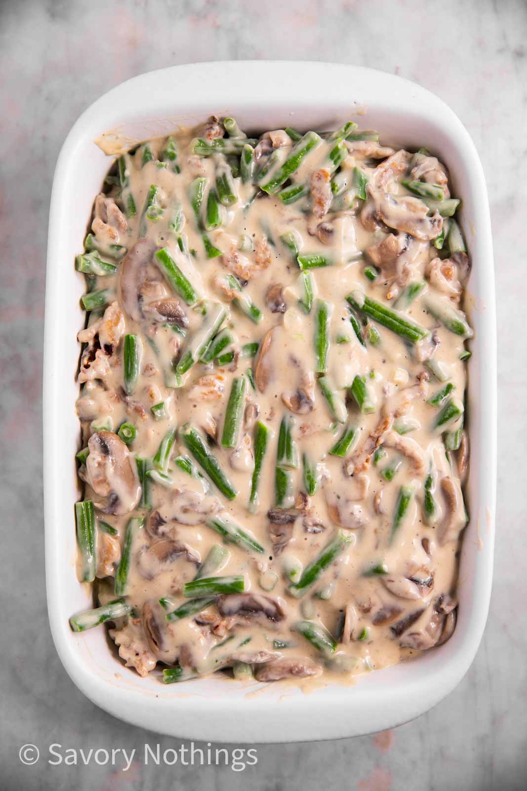 unbaked green bean casserole in white dish