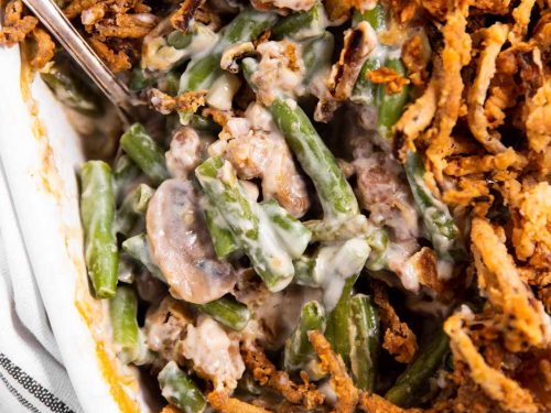 overhead view of green bean casserole with spoon stuck inside