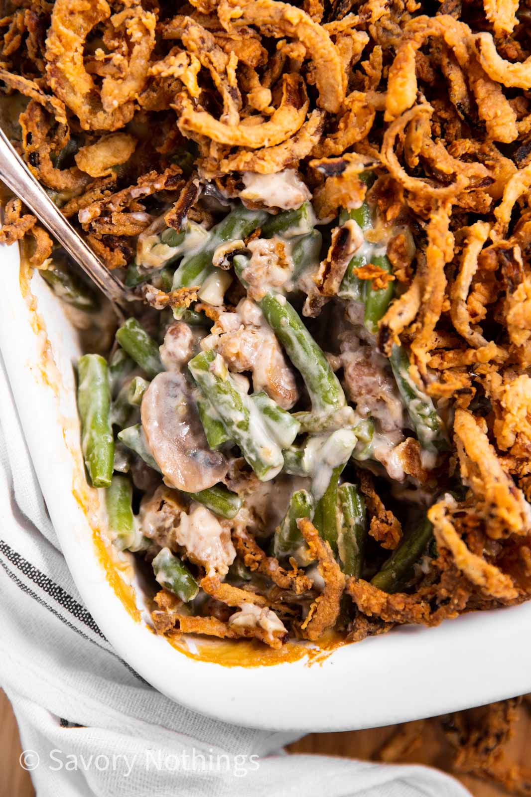 overhead view of green bean casserole with spoon stuck inside