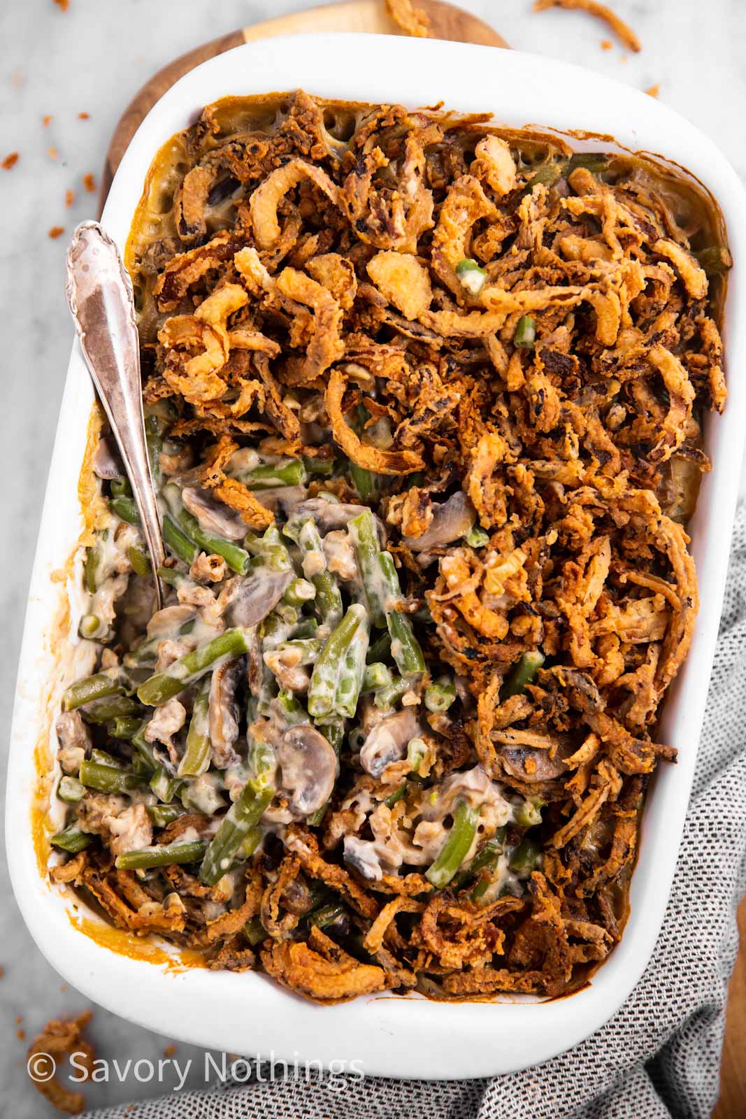 overhead view of white casserole dish filled with green bean casserole