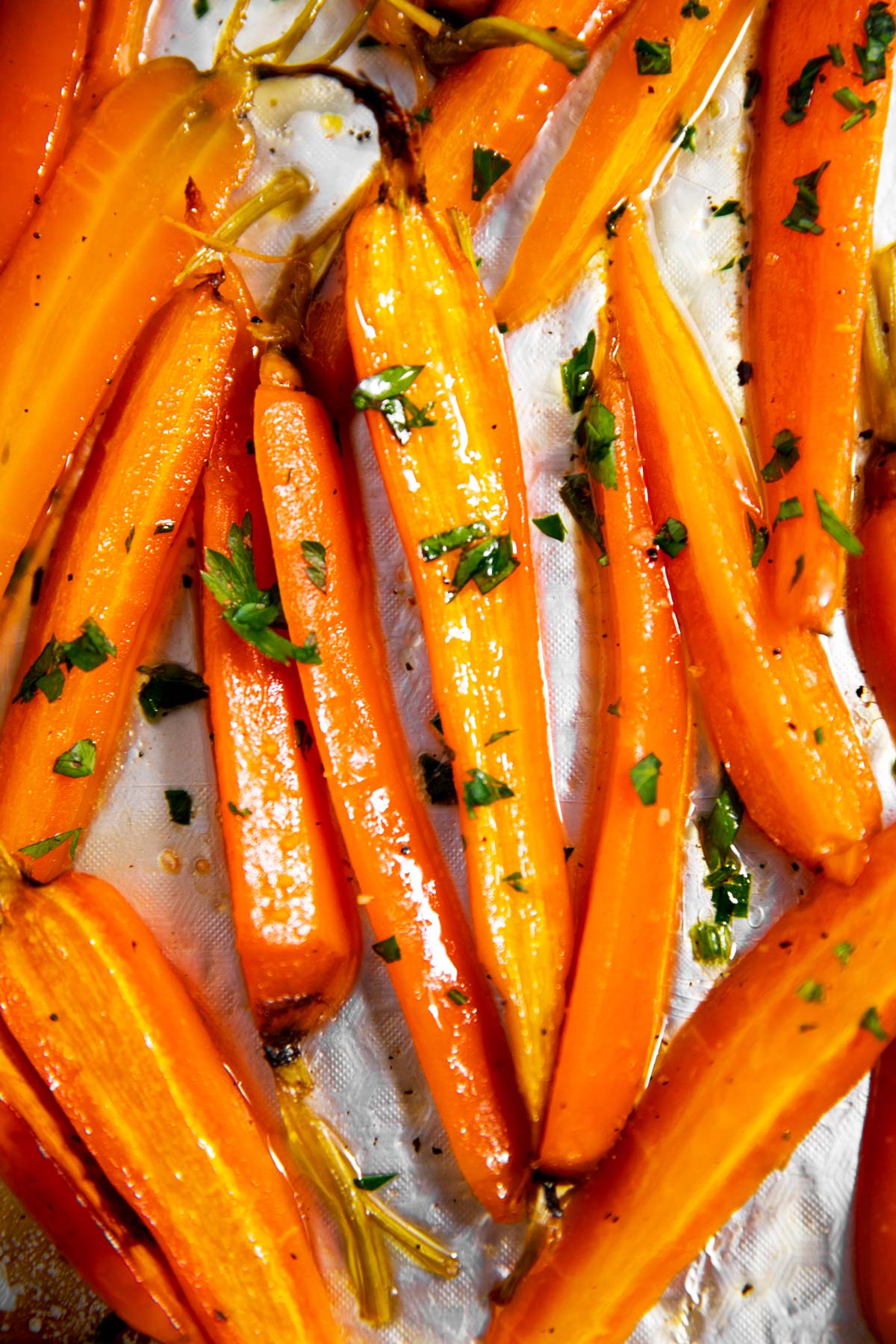 close up photo of roasted carrots with chopped parsley