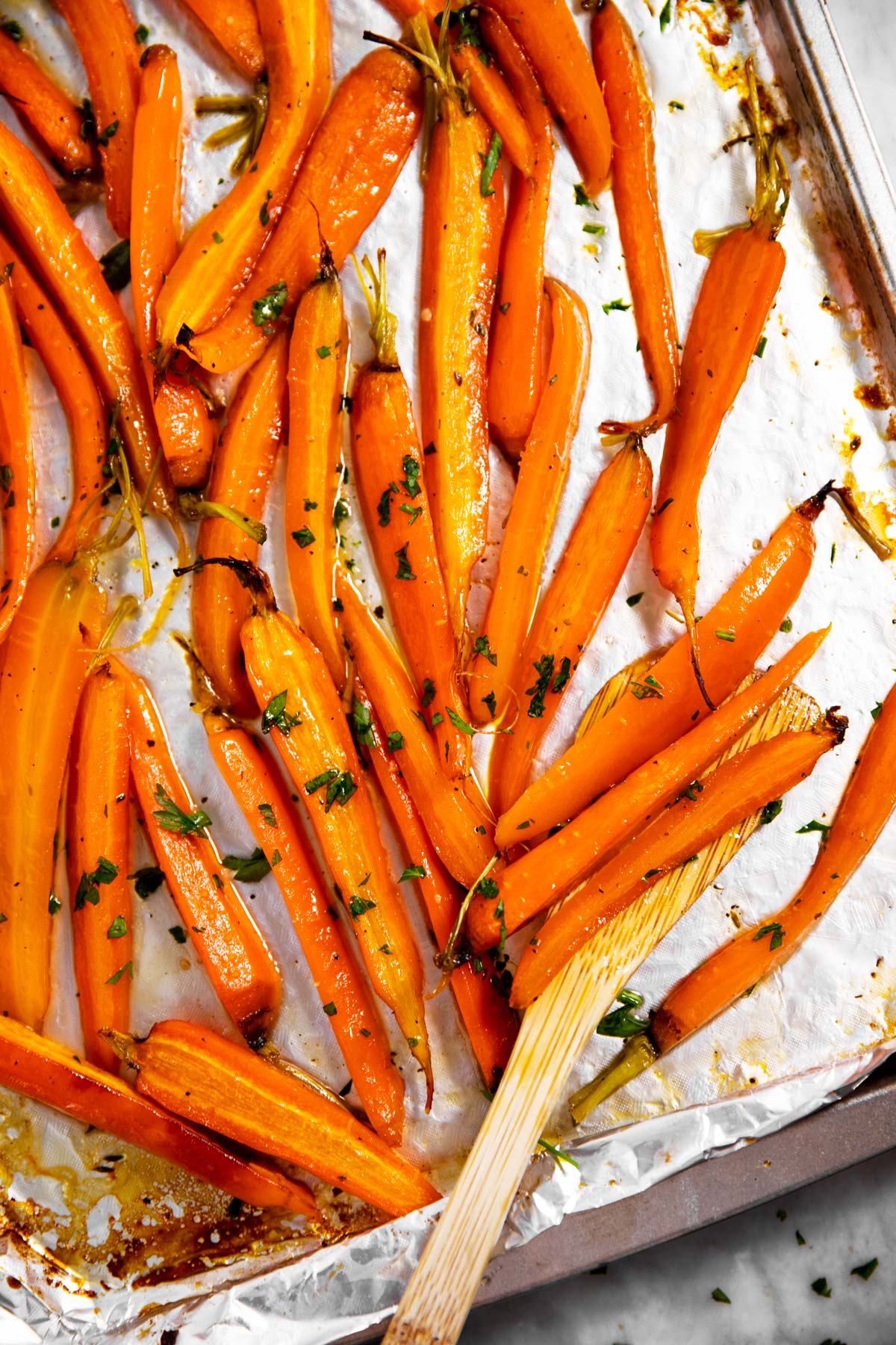 overhead view of roasted carrots on foil lined pan