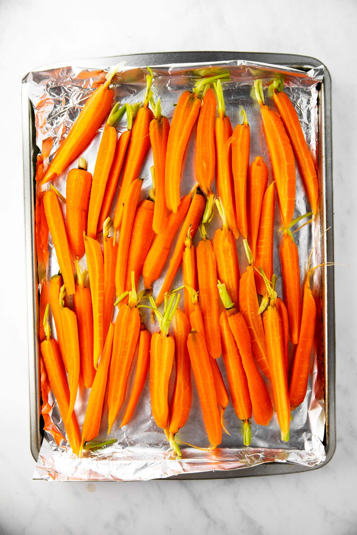 raw carrots on foil lined pan