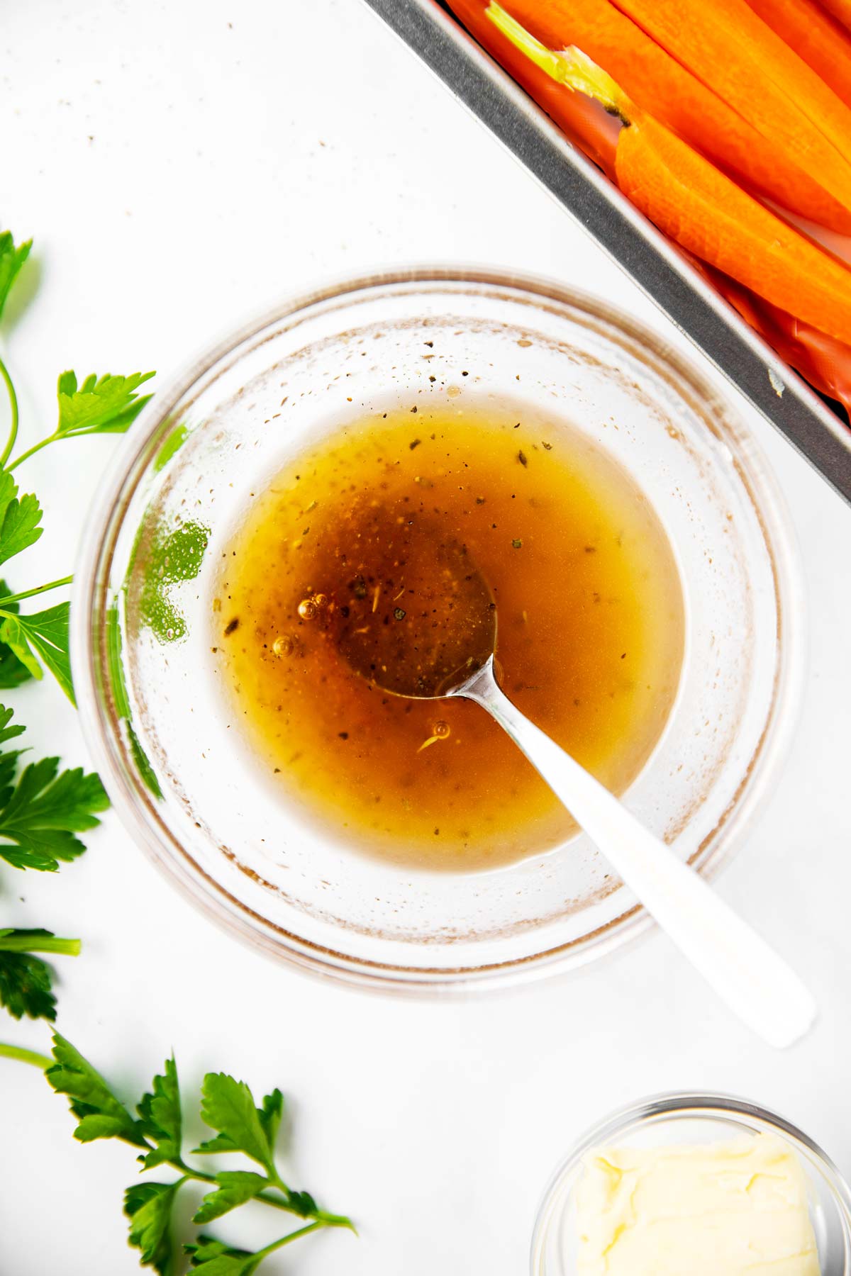 overhead view of small glass bowl filled with honey glaze