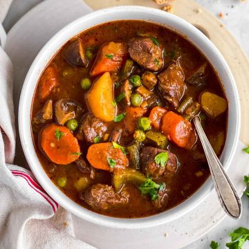 overhead view of white bowl filled with instant pot beef stew