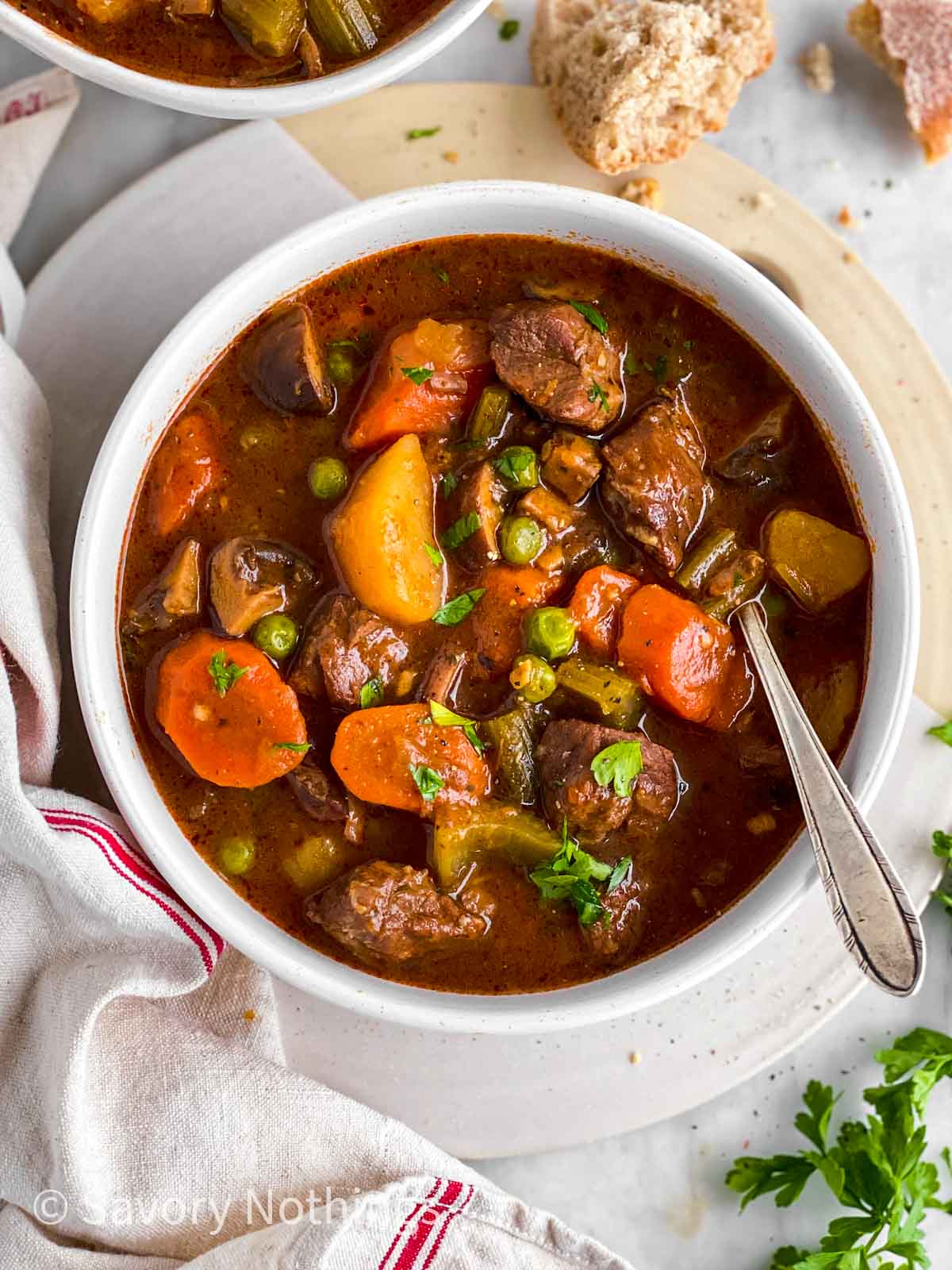 overhead view of white bowl filled with instant pot beef stew