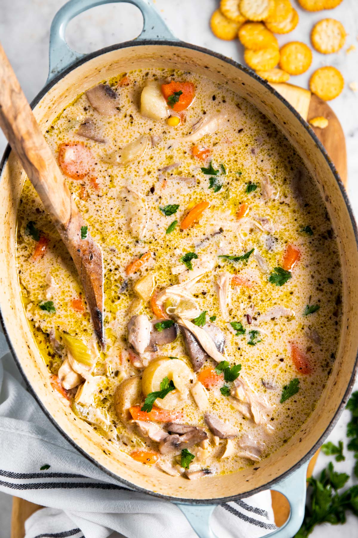 leftover turkey soup in Dutch oven with wooden spoon