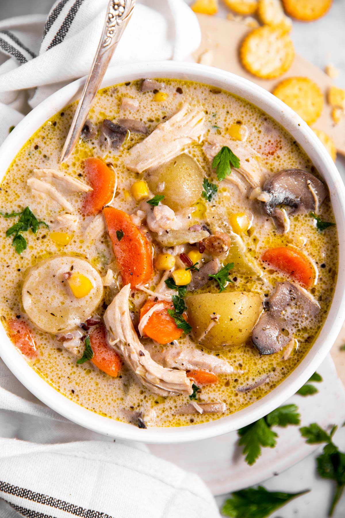 bowl with turkey soup surrounded by oyster crackers