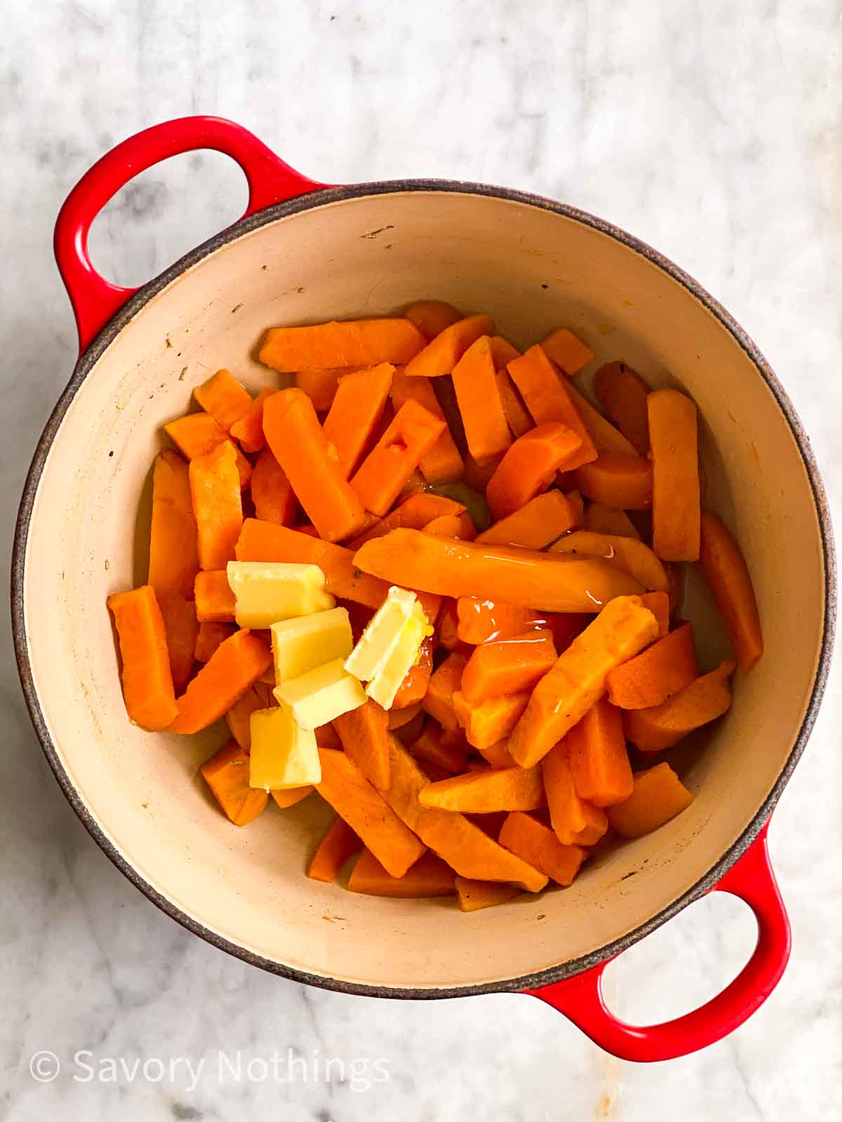 cooked sweet potatoes in pot with butter