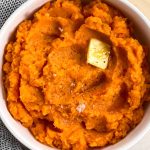 close up photo of bowl filled with mashed sweet potatoes