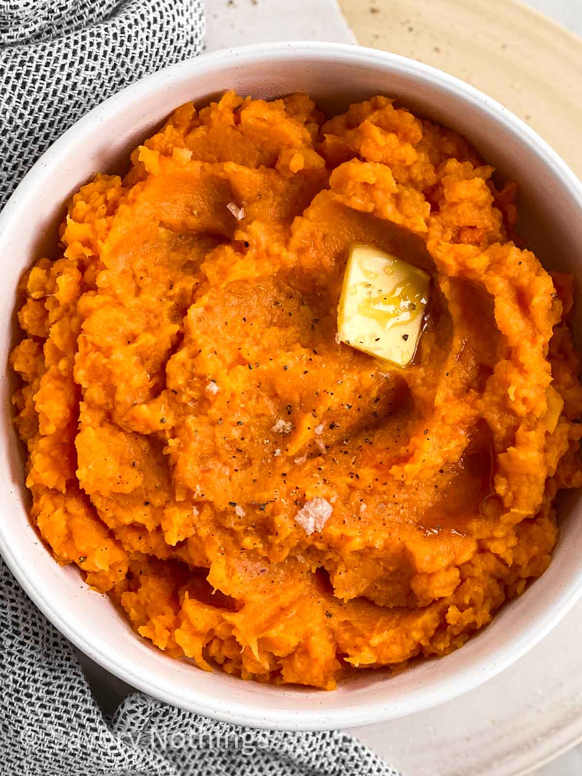 close up photo of bowl filled with mashed sweet potatoes