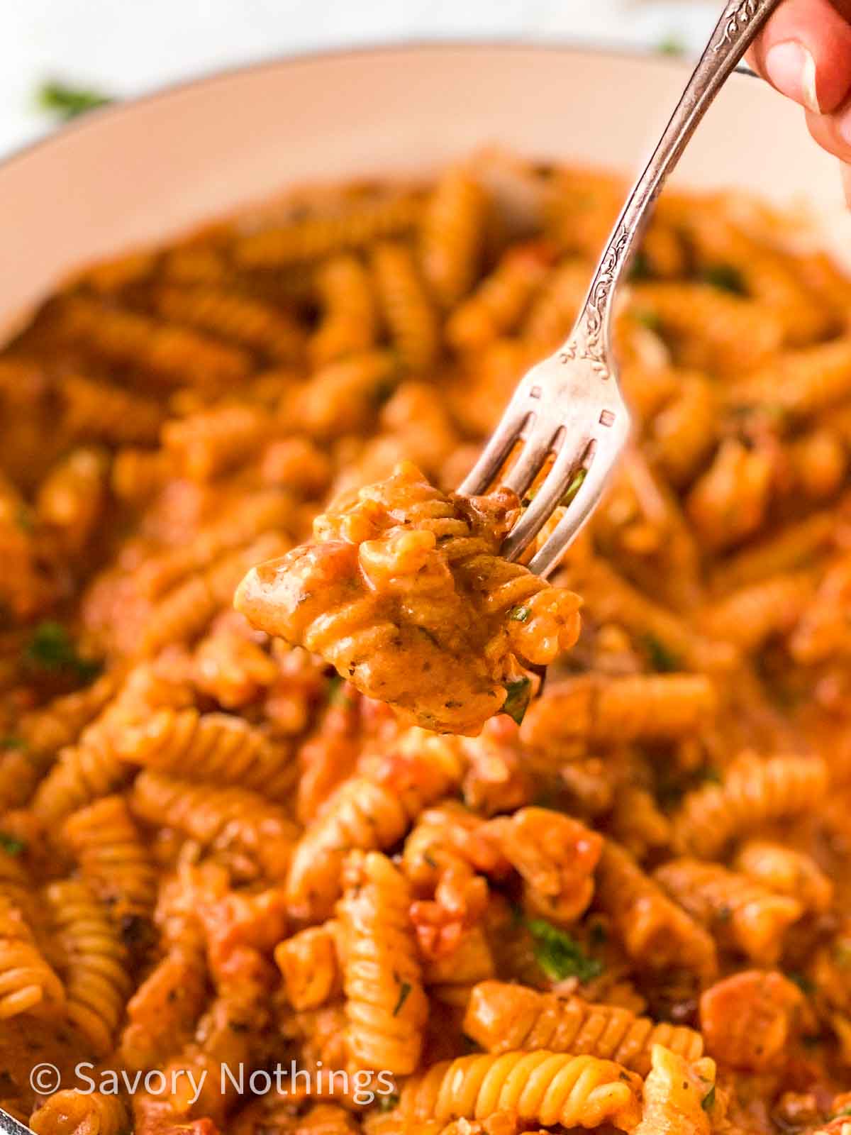 close up photo of creamy tomato pasta on a fork