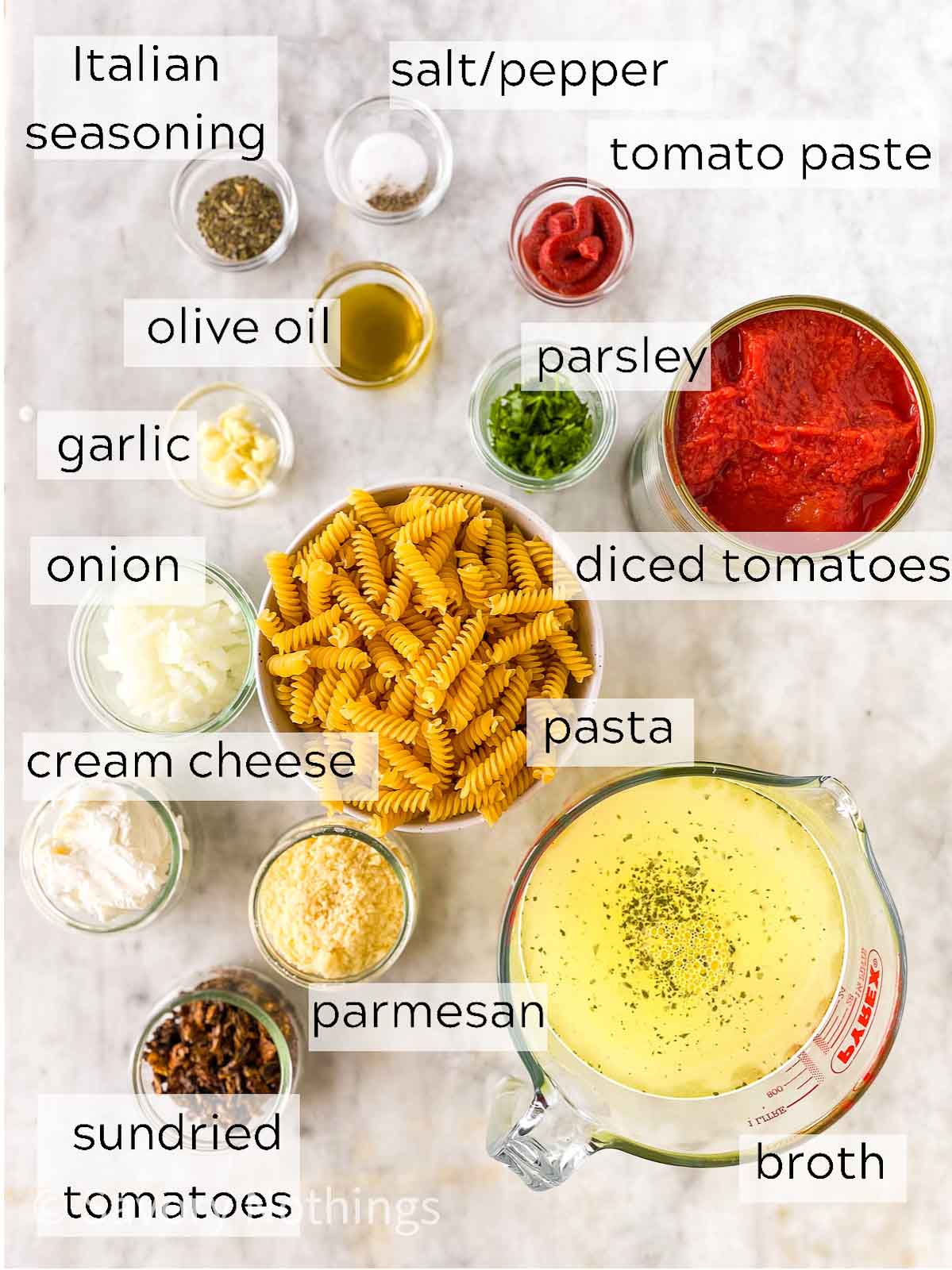 ingredients for creamy tomato pasta with text labels
