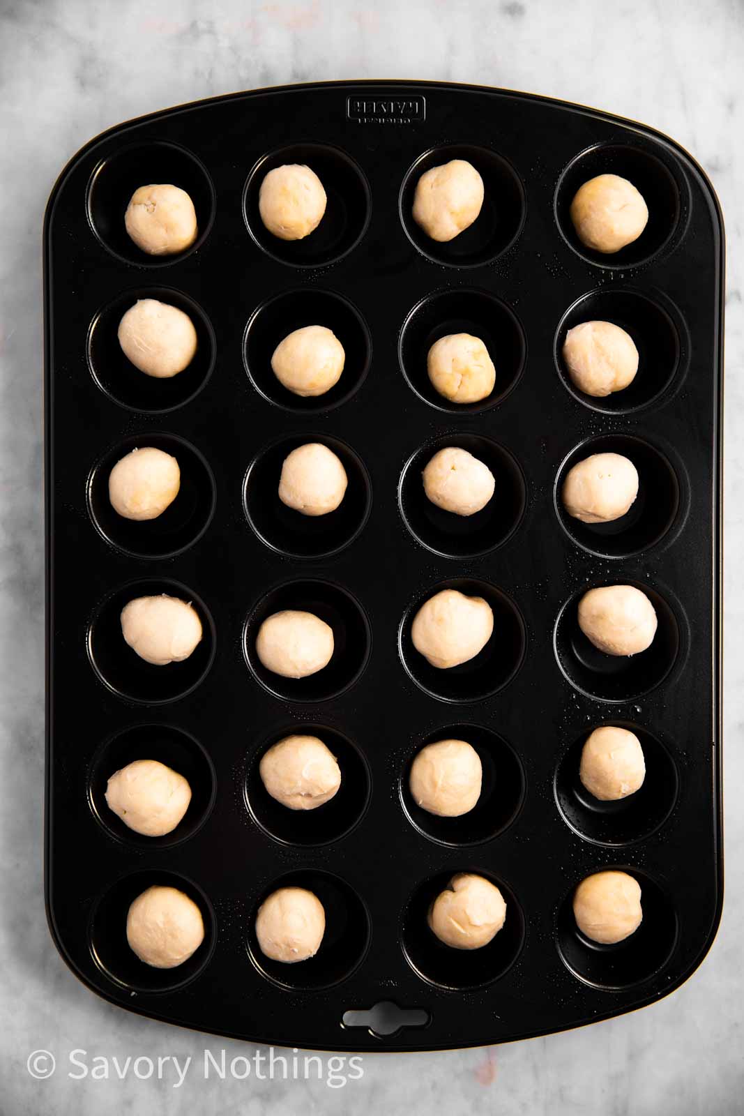 rolled pastry dough balls in mini muffin pan