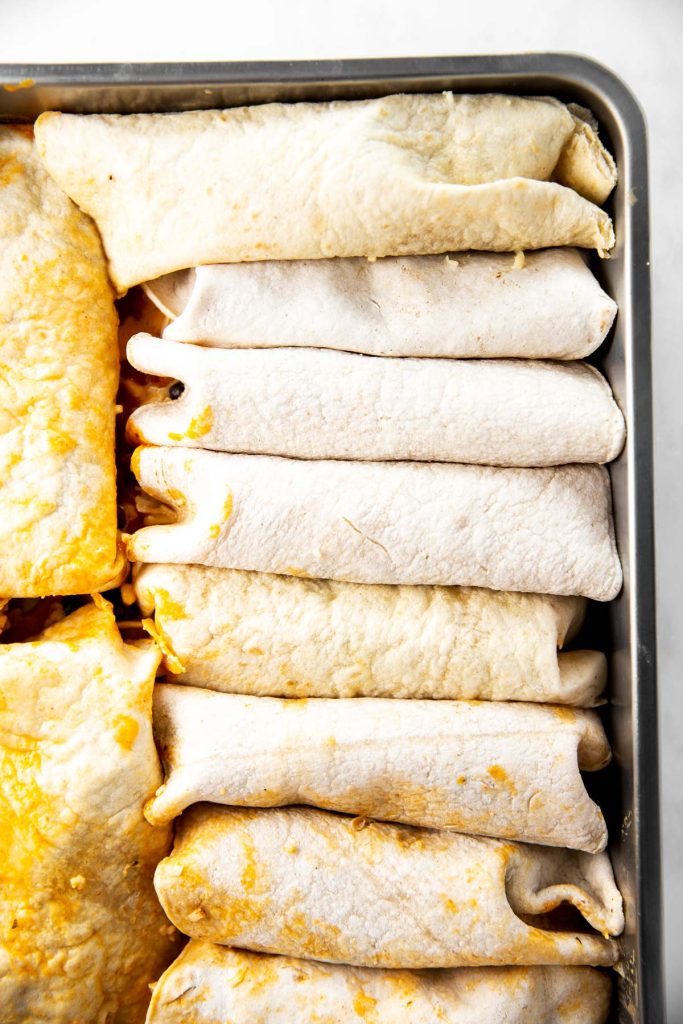 rolled turkey enchiladas in casserole dish