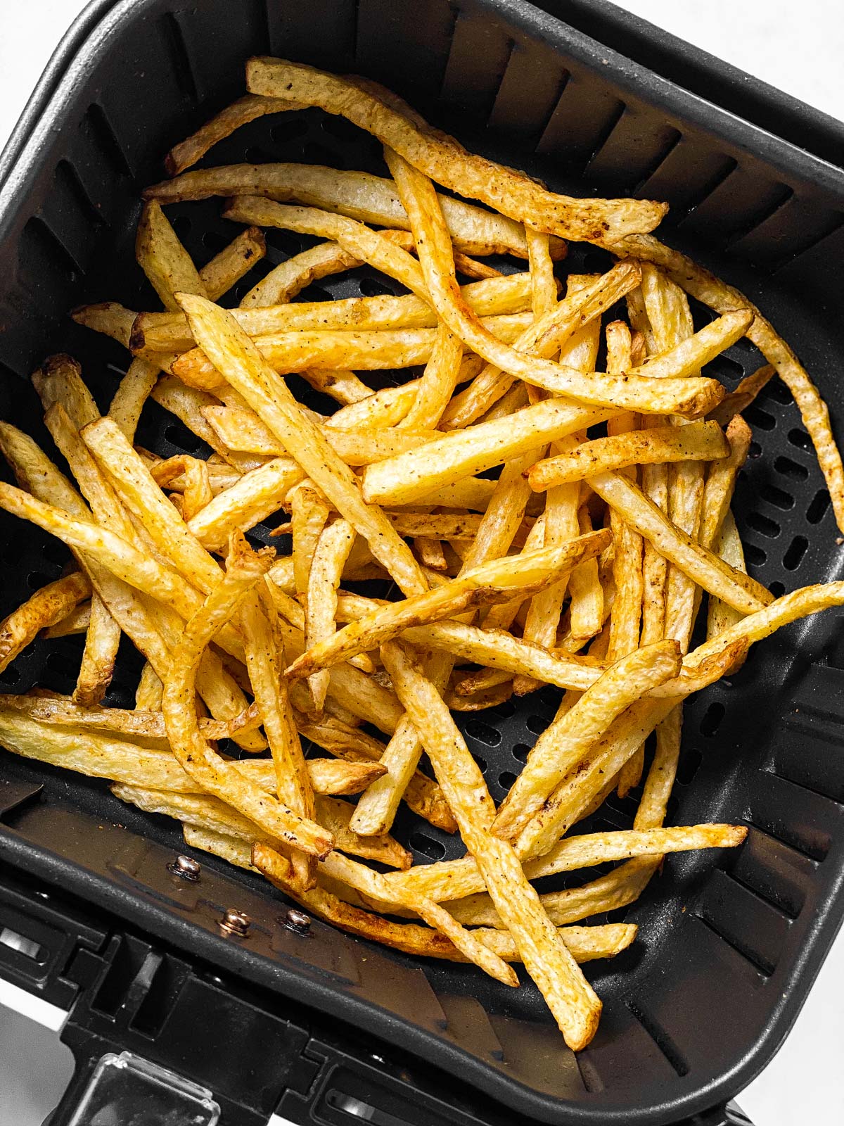 overhead view of french fries in air fryer basket