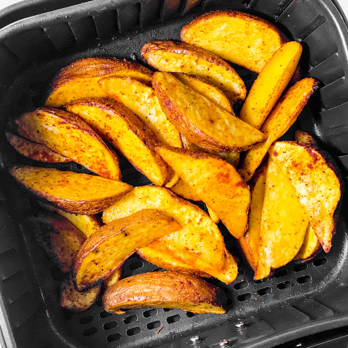 cooked potato wedges in air fryer basket