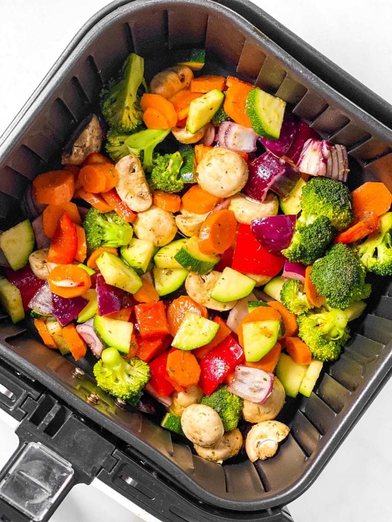 seasoned vegetables in air fryer basket