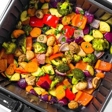 overhead view of roasted vegetables in air fryer basket