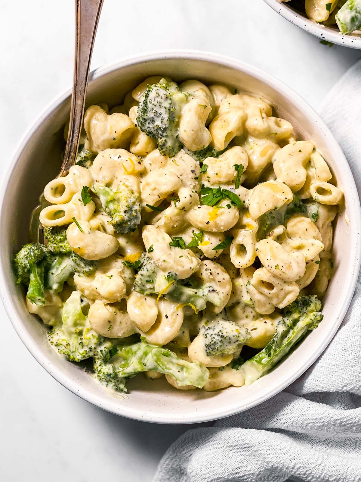 overhead view of broccoli pasta in white bowl