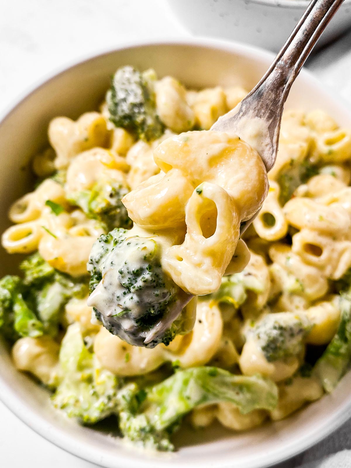 close up photo of fork with broccoli pasta