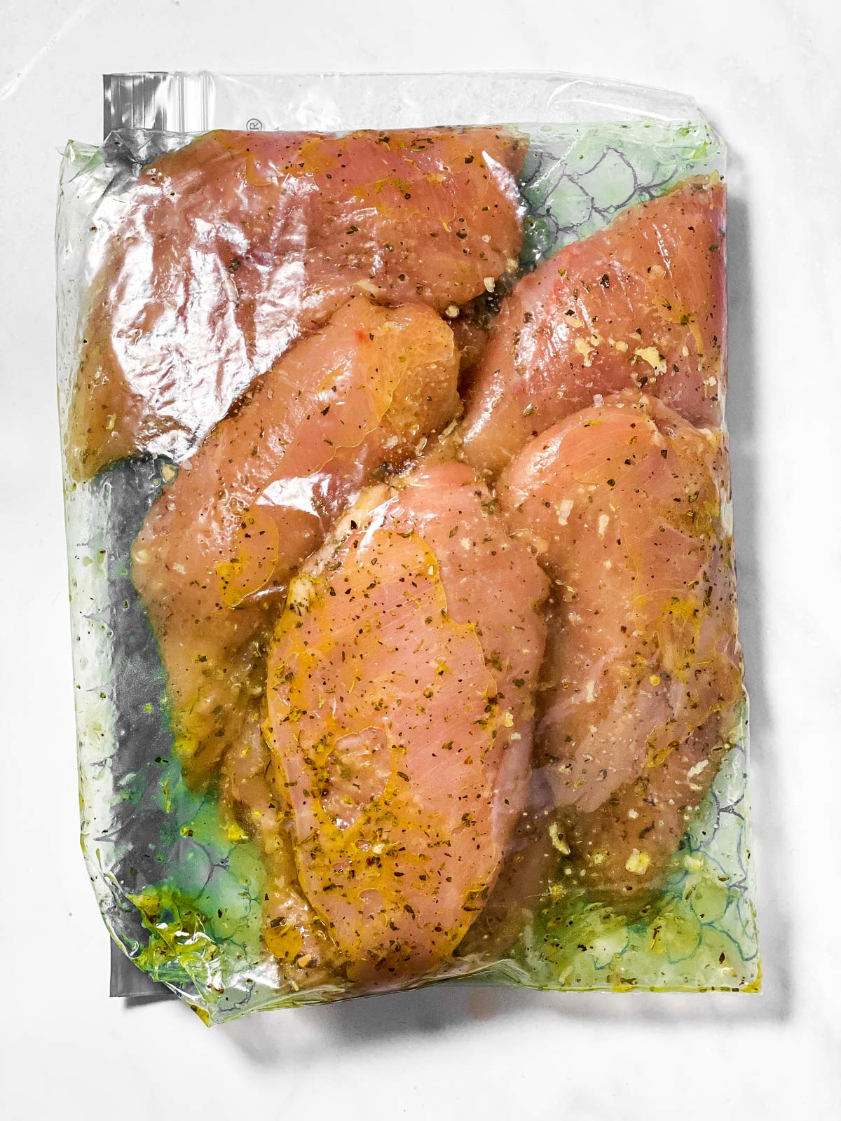 chicken breast in plastic bag with marinade